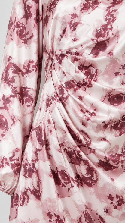 Close-up detail of fabric pattern and ruched waist on pink dress