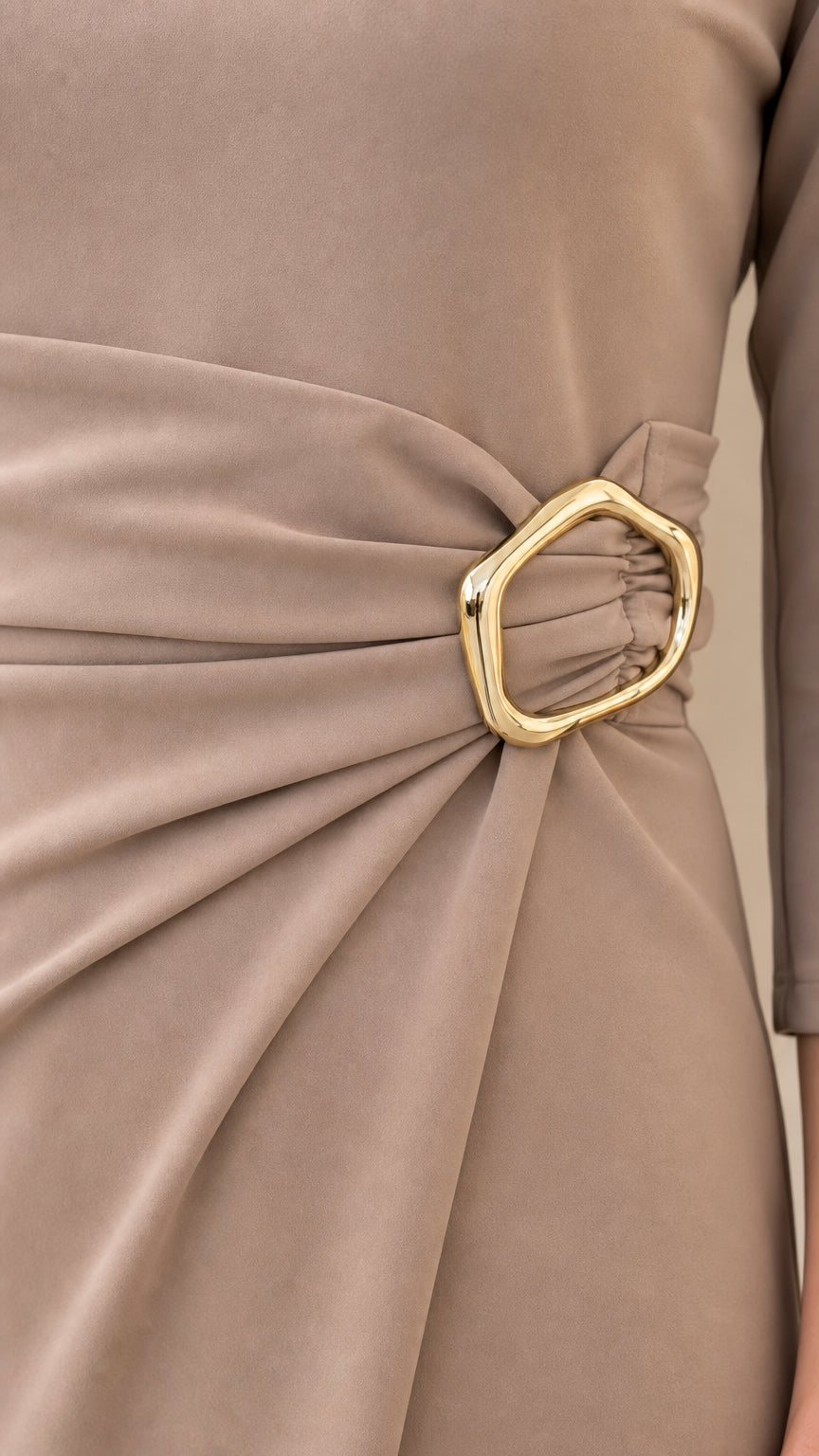 Close-up detail of side waist pleating and organic gold-tone metal buckle