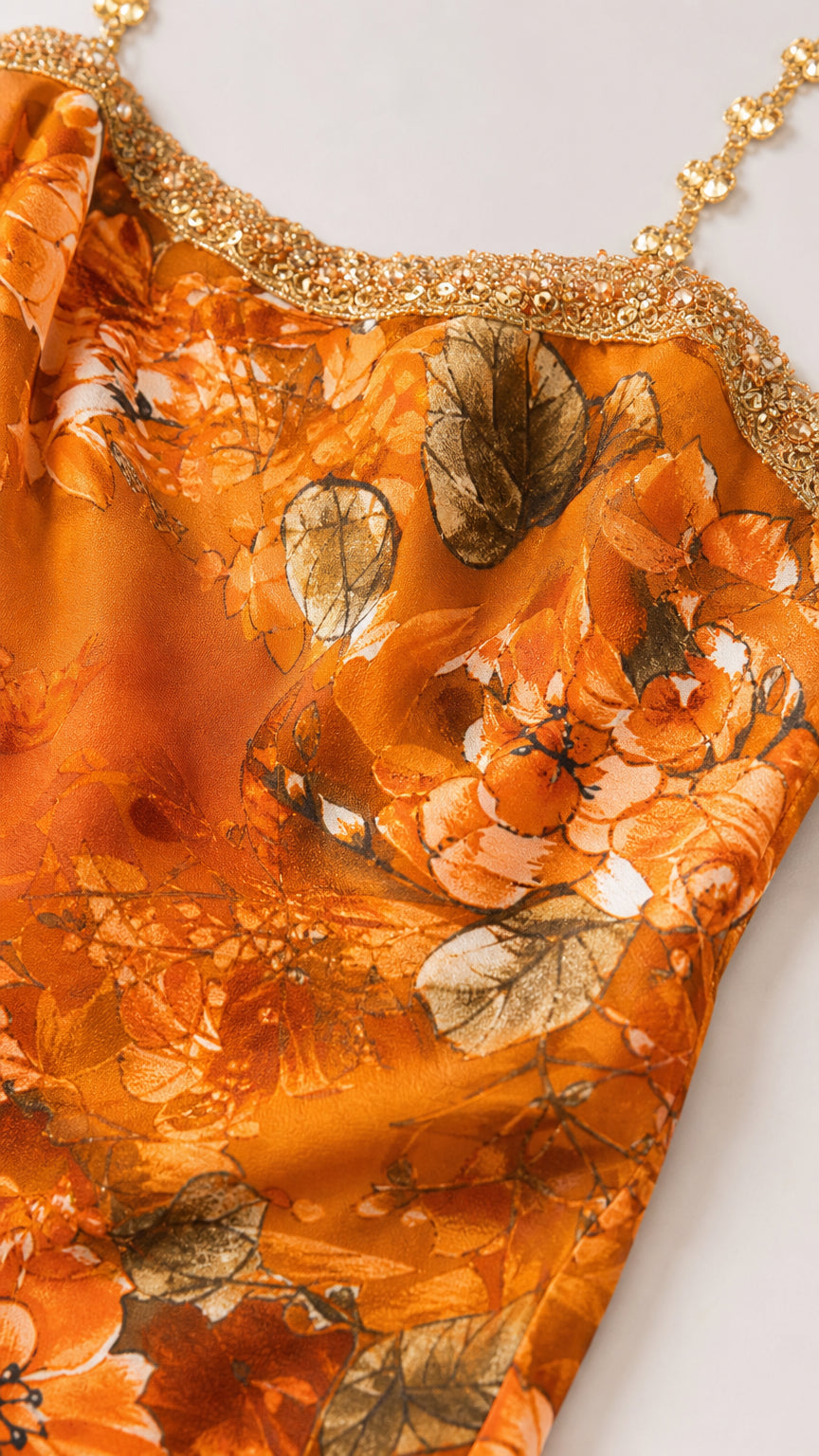 Close-up of rhinestone embellished neckline and orange floral fabric