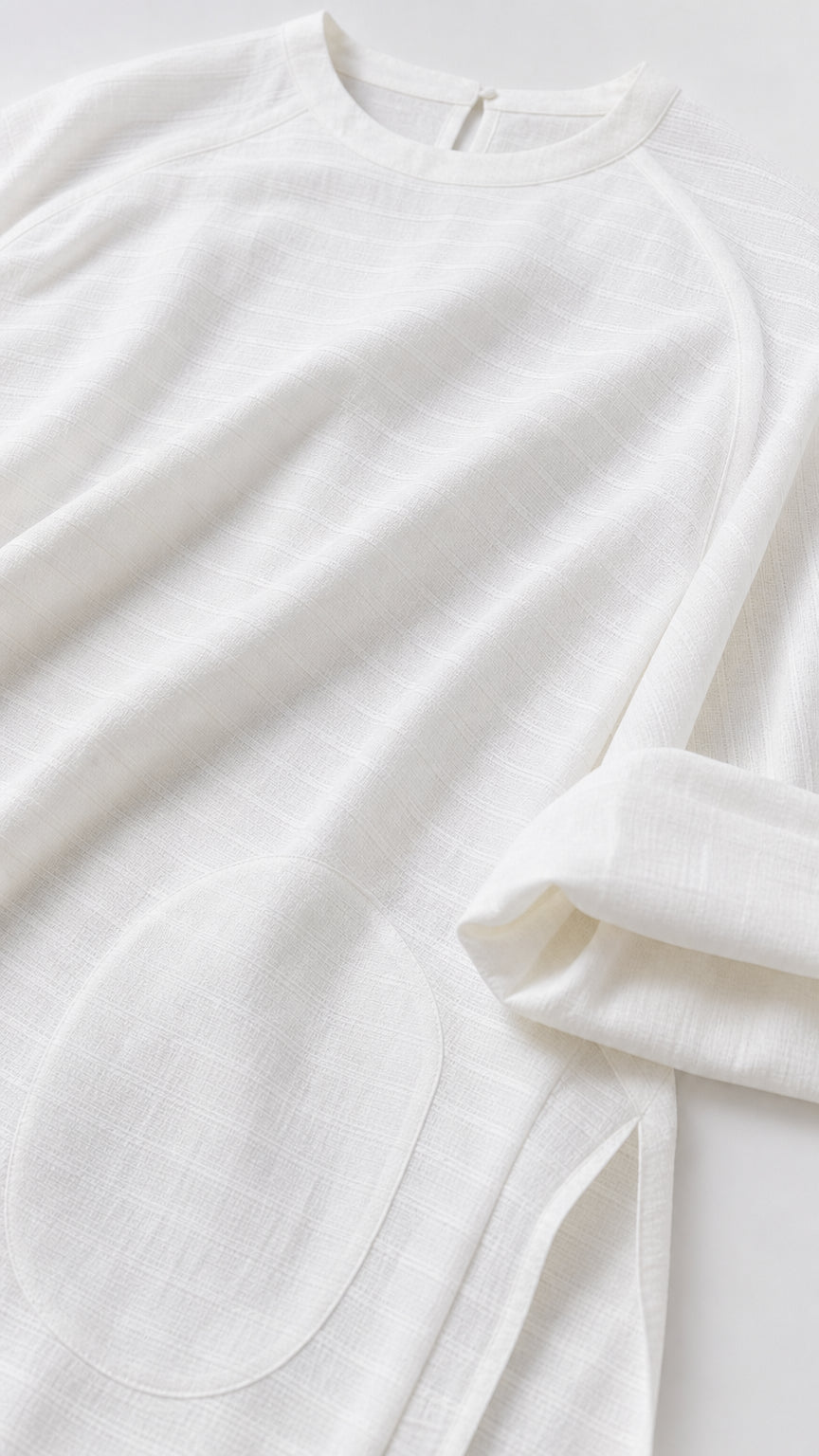 Close-up of white textured fabric and pocket detail