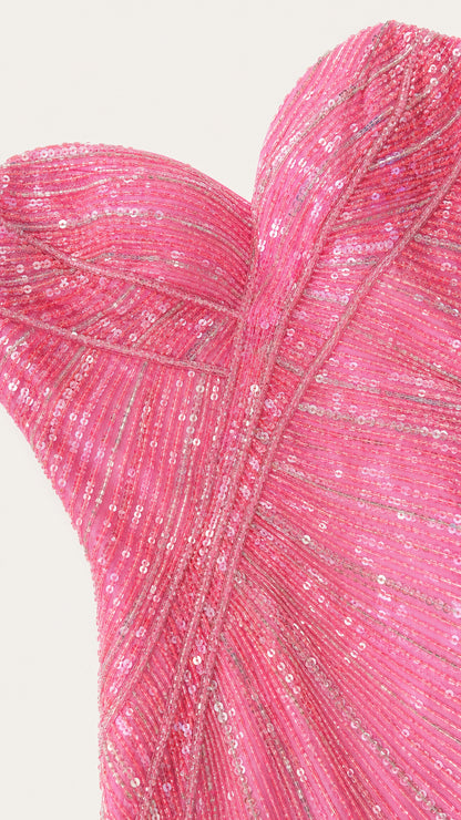 Close-up detail of hot pink sequin fabric and sweetheart neckline