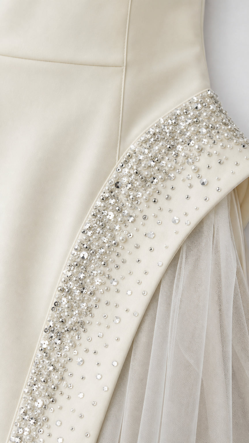 Close-up of rhinestone and crystal embellishments on ivory gown