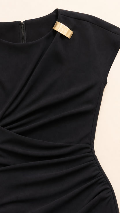 Close-up detail of gold shoulder hardware and ruched bodice