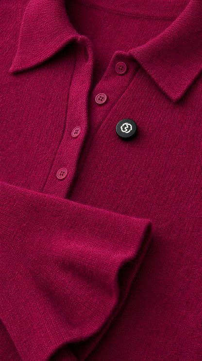 Close-up detail of magenta knit fabric, polo collar, and buttons