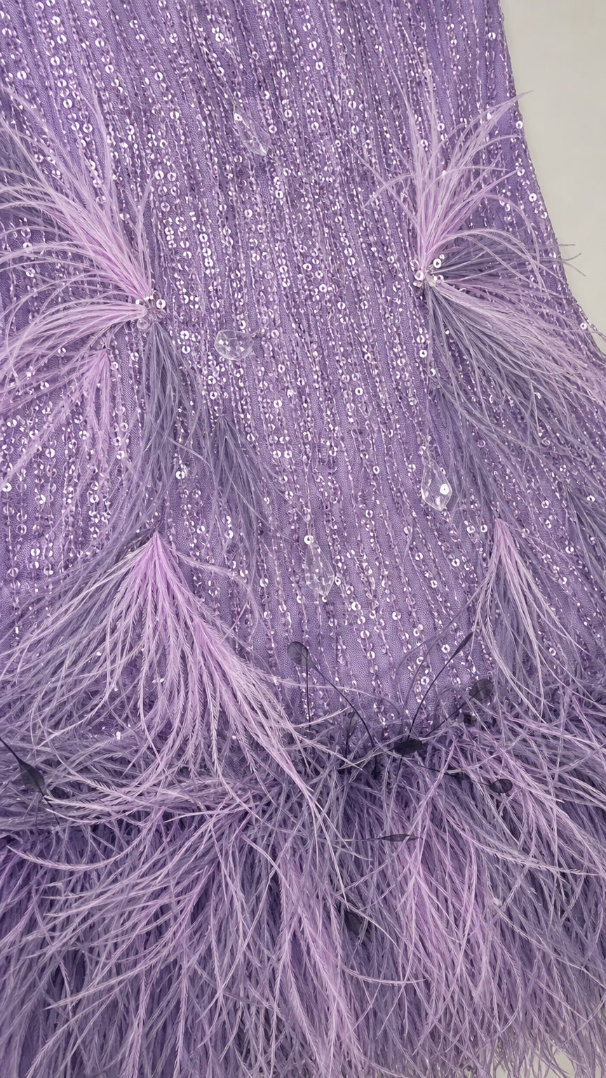 Close-up detail of sequins and feather trim on lavender dress