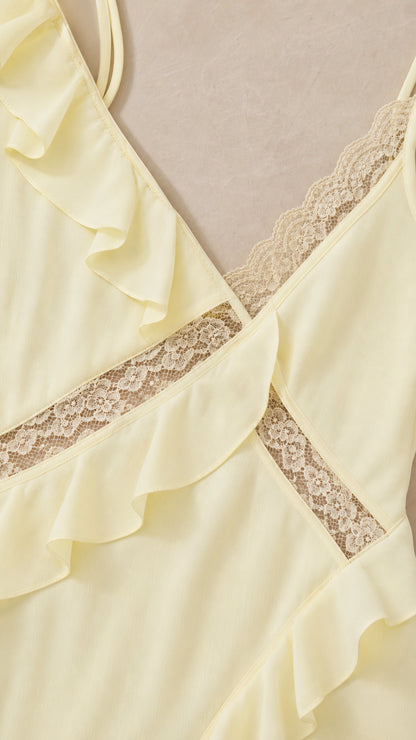 Close-up detail of lace trim and ruffle on yellow dress