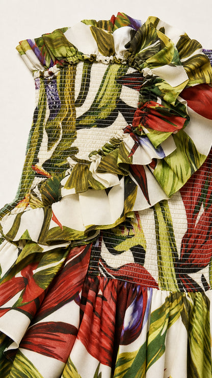 Close-up detail of smocked bodice and ruffled neckline in tropical print