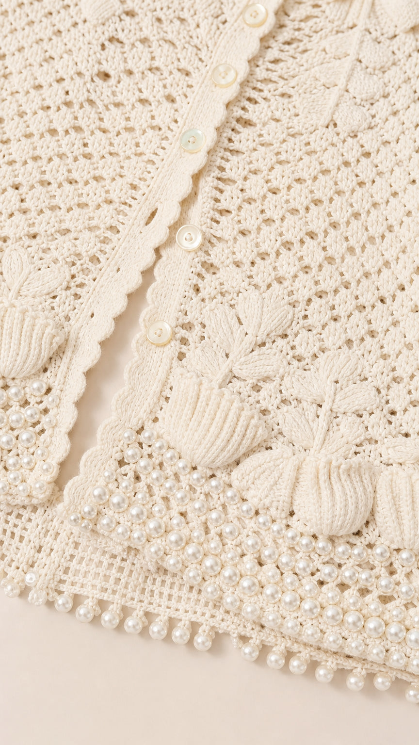 Close-up detail of white crochet knit pattern and pearl bead trim