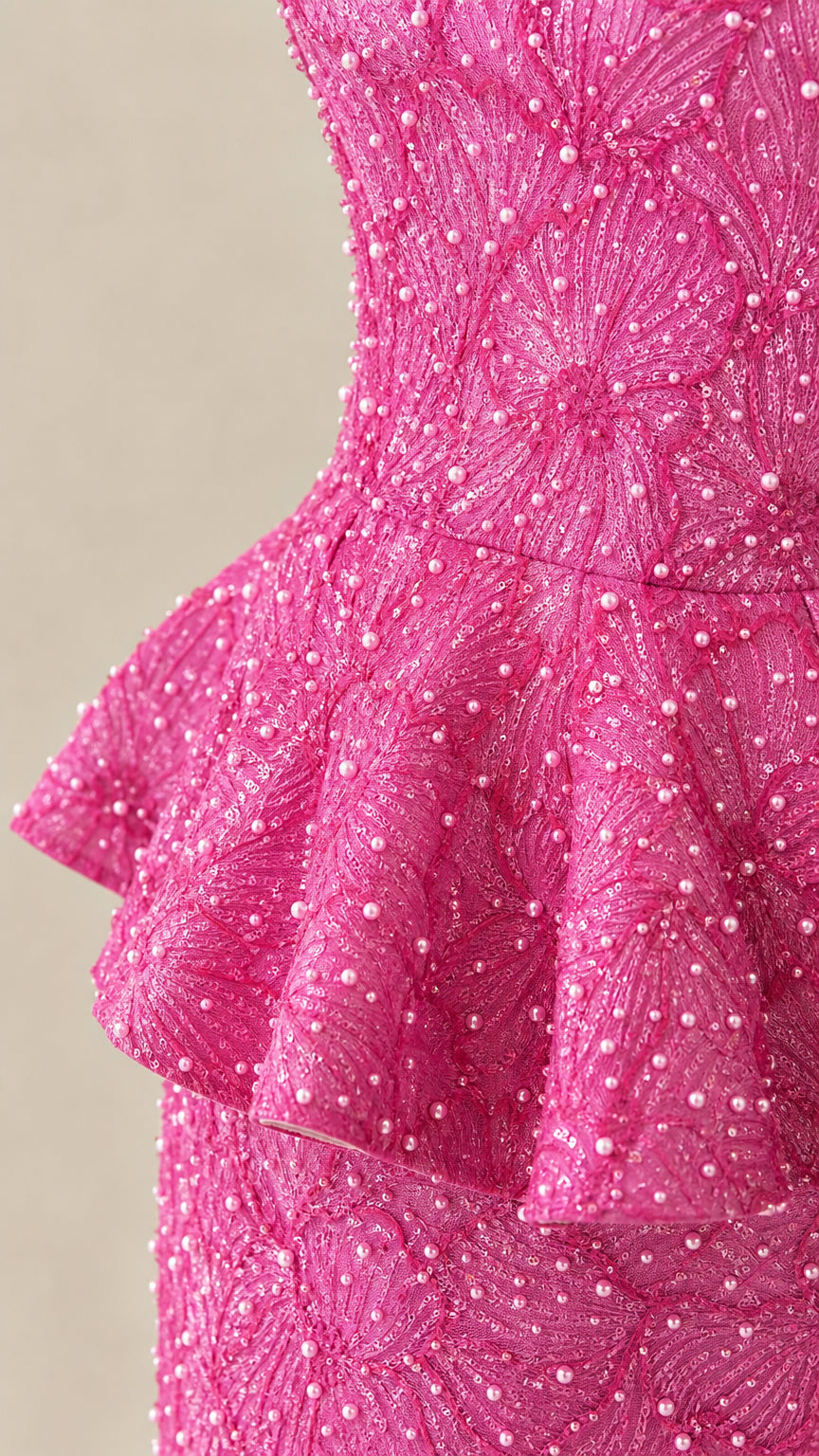 Close-up detail of beadwork and peplum waist on evening gown