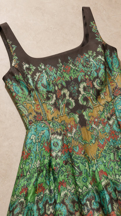 Close-up detail of square neckline and tapestry pattern fabric