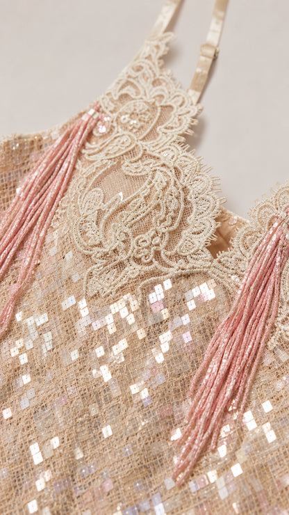 Close-up detail of lace trim and sequin texture on evening dress