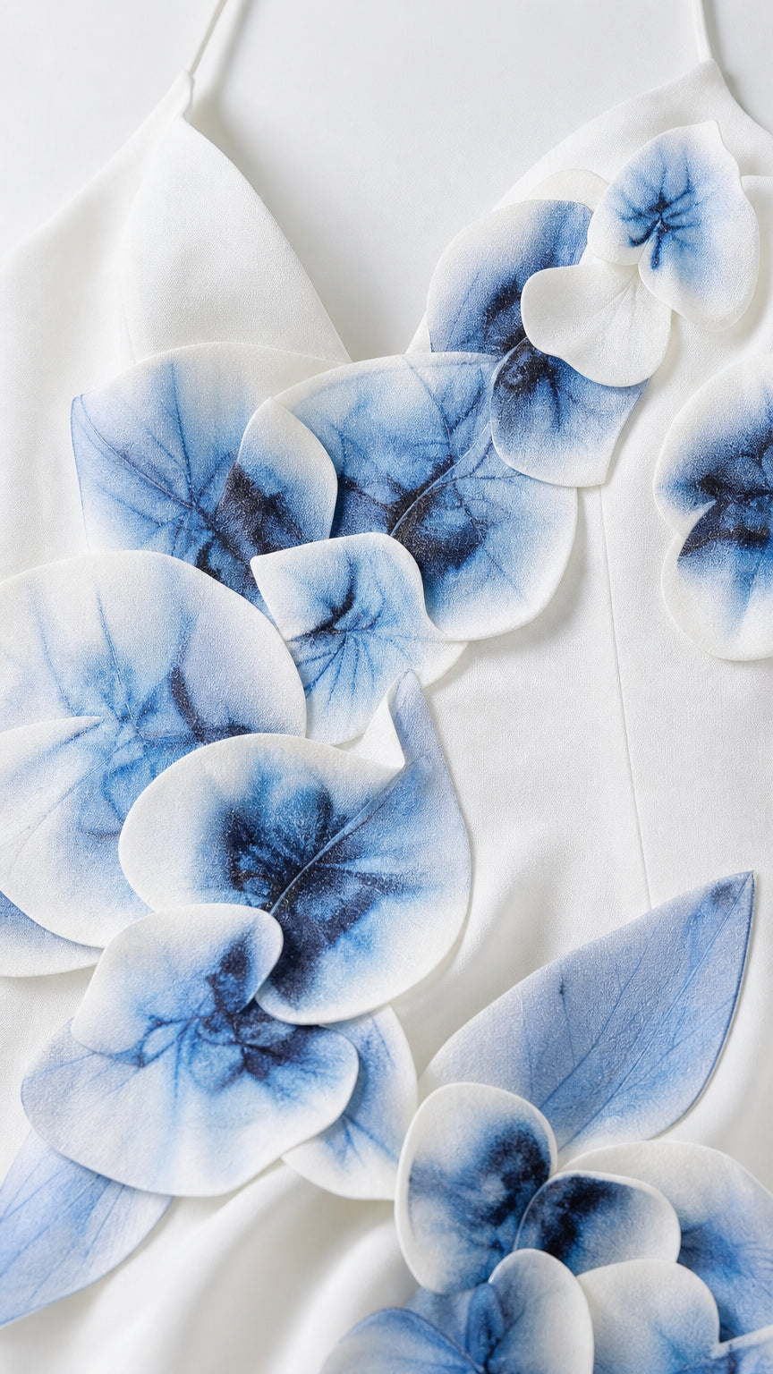 Close-up detail of blue-and-white 3D floral appliques