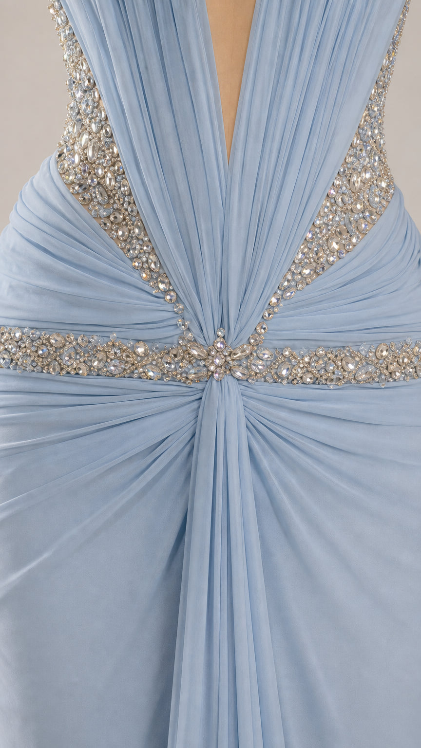 Close-up of crystal-look embellishment and gathered ruching on the ice blue gown