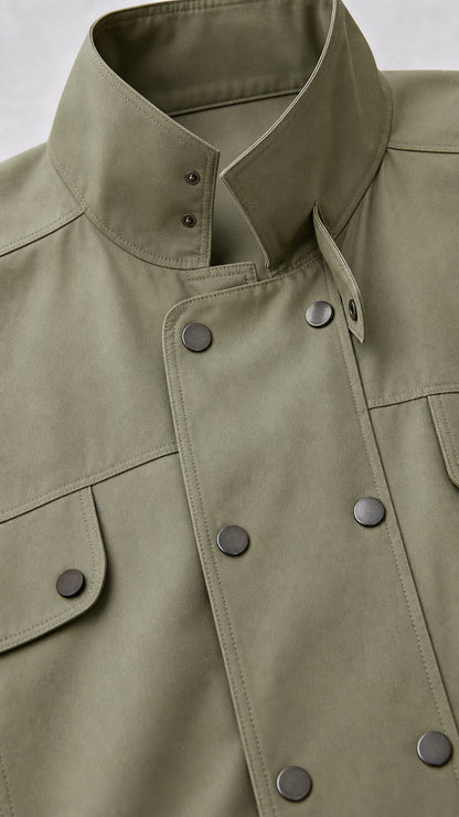 Close-up detail of high collar and double-breasted snap buttons