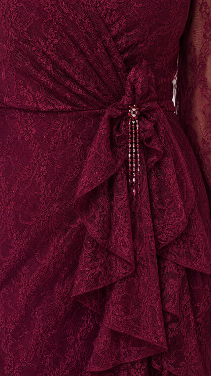 Close-up of beaded waist detail and ruffle trim on burgundy dress