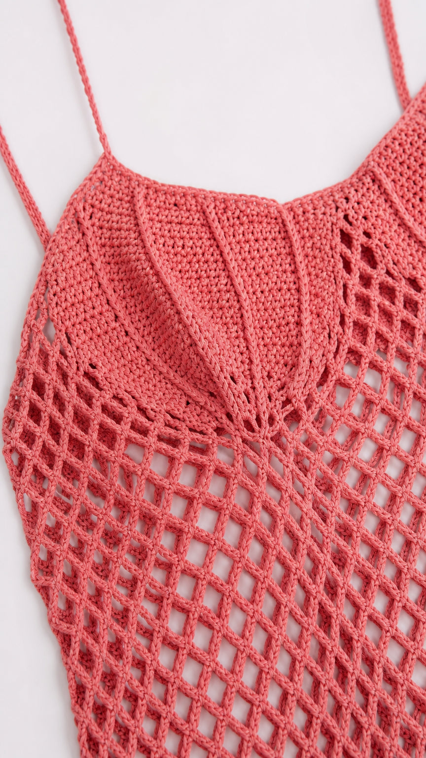 Close-up of pink bodice and net-stitch detail of crochet dress