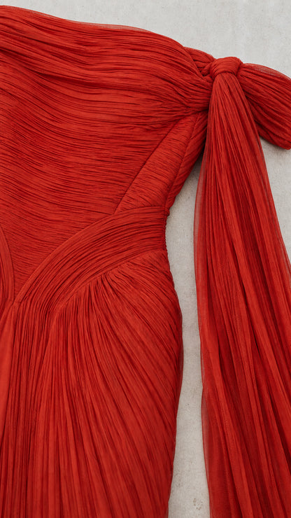 Close-up of pleated texture and sleeve knot on red dress