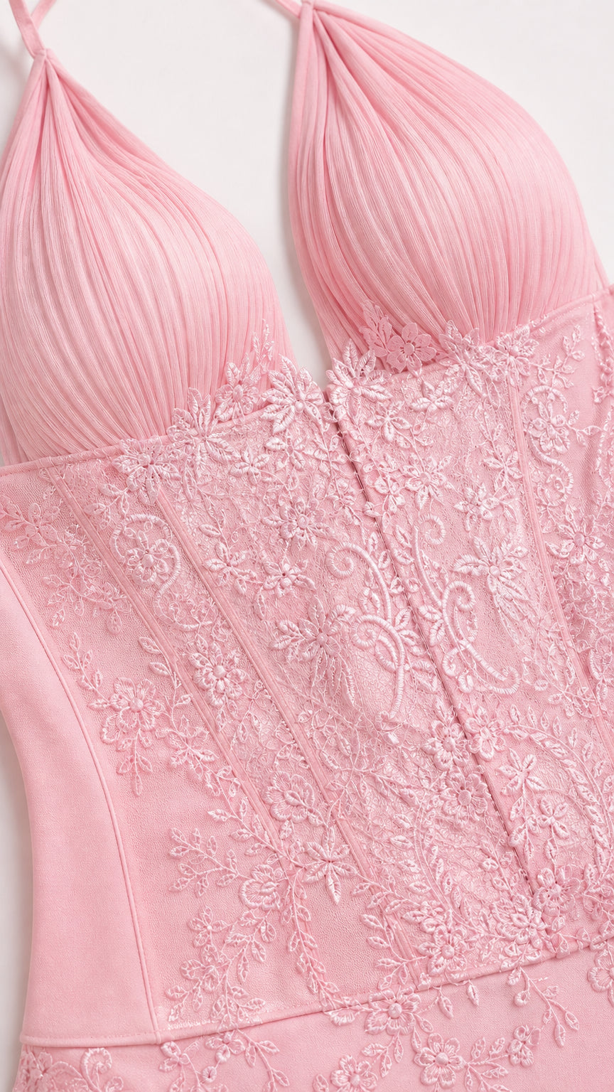 Close-up of bodice lace embroidery and pleated texture on pink dress