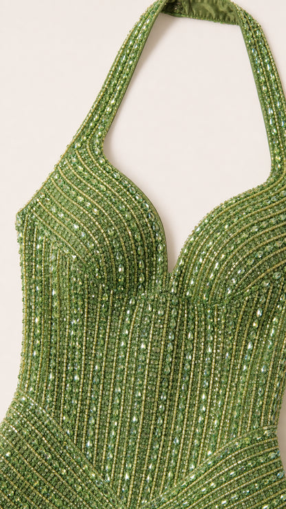 Close-up detail of halter neckline and beadwork on green dress