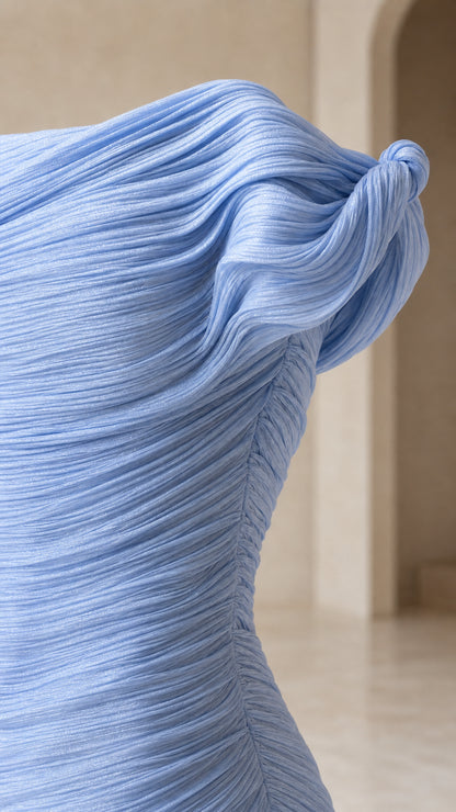 Close-up detail of the textured pleated fabric and shoulder knot
