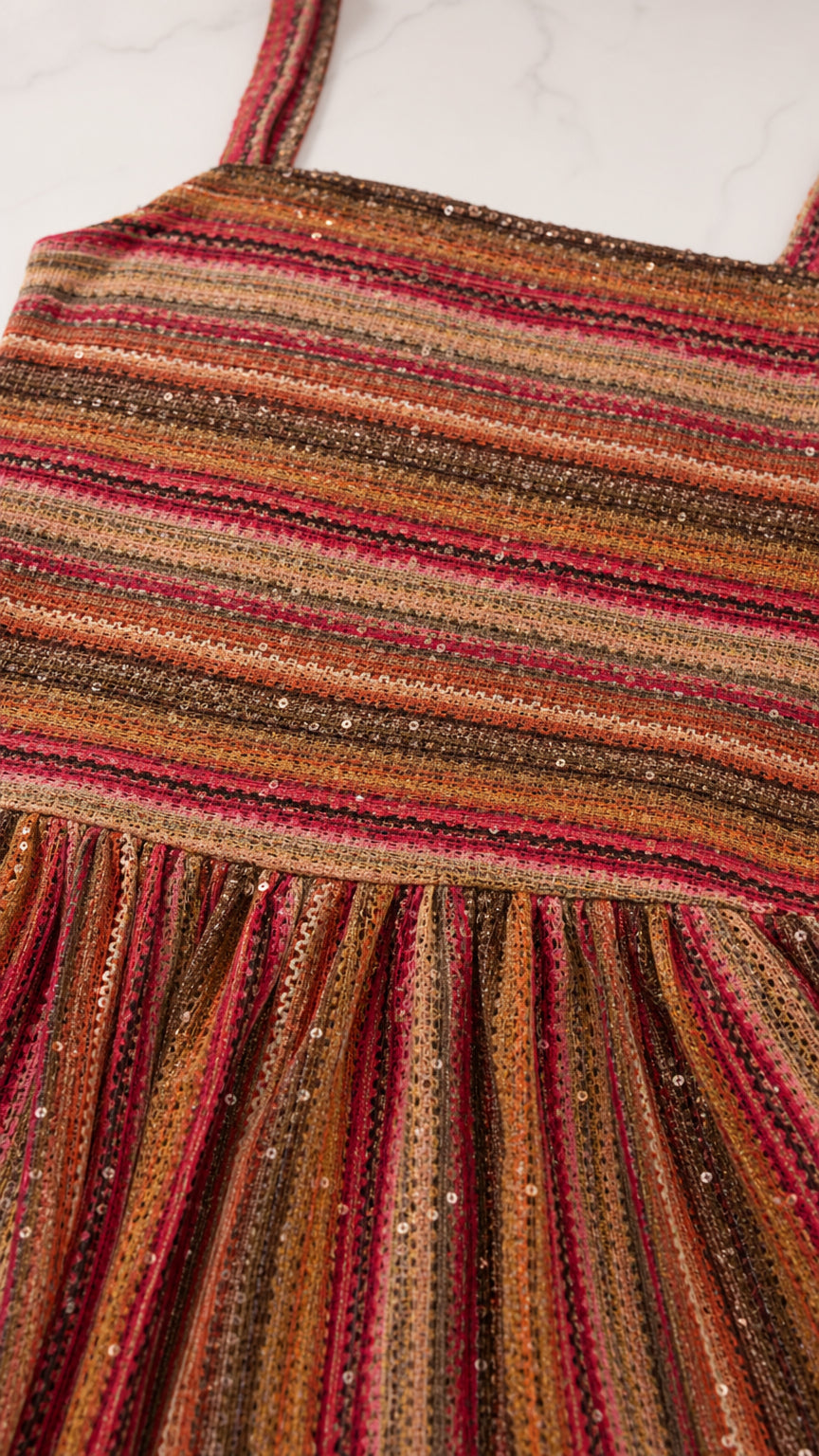 Close-up detail of red multi striped smocked bodice and skirt