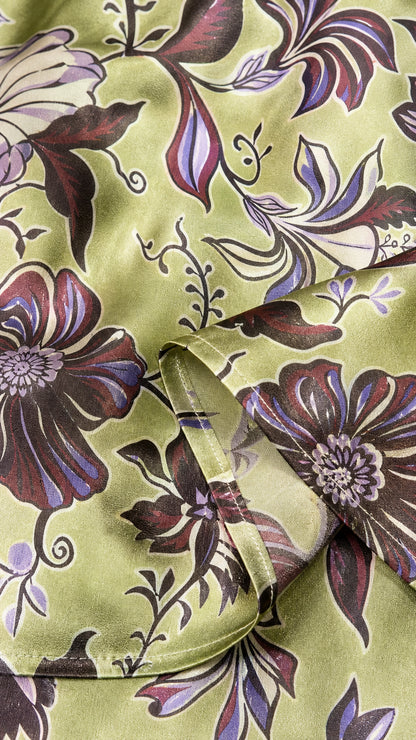 Close-up of green floral satin fabric texture