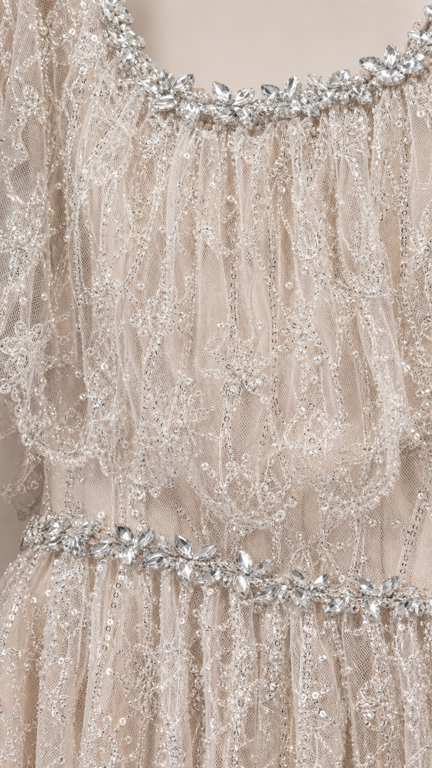 Close-up of rhinestone beading at neckline and waist on champagne lace dress