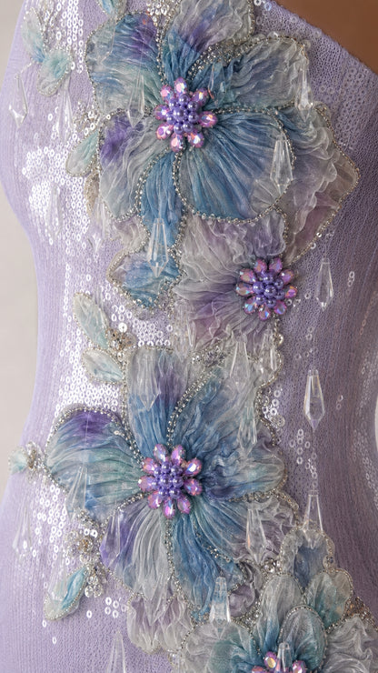 Close-up of 3D floral appliques and sequin detail on lavender dress