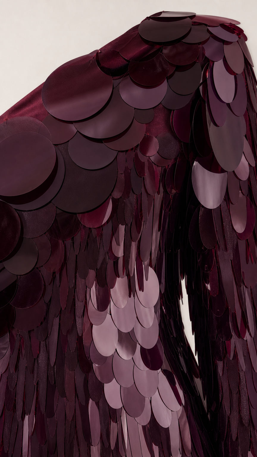 Close-up detail of oversized sequins and fringe texture