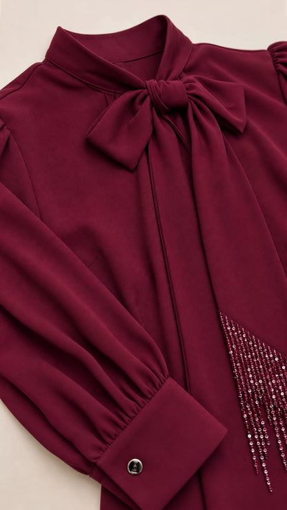Close-up of bow neckline and rhinestone detailing