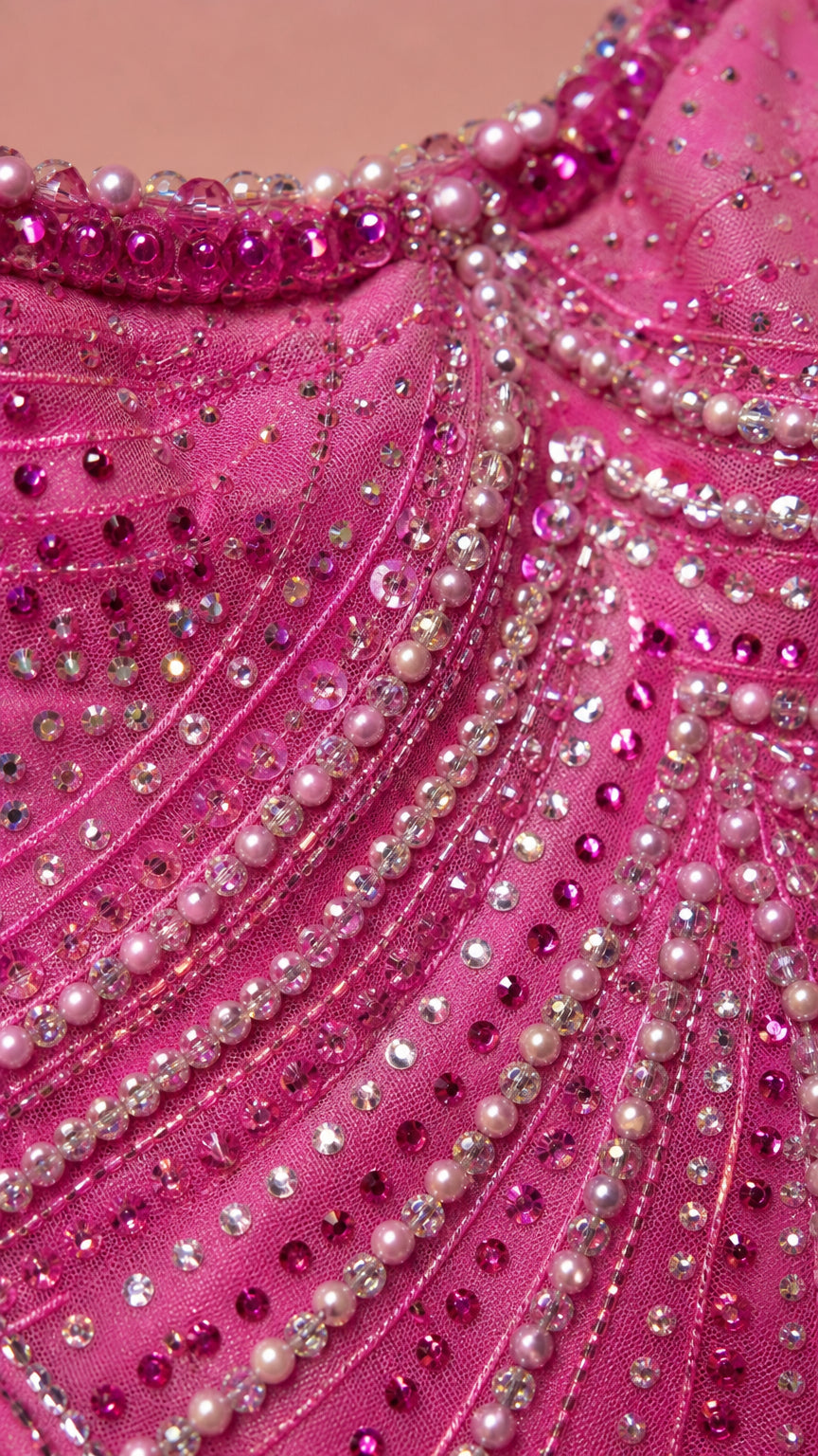 Close-up of intricate crystal and bead embellishments on pink dress