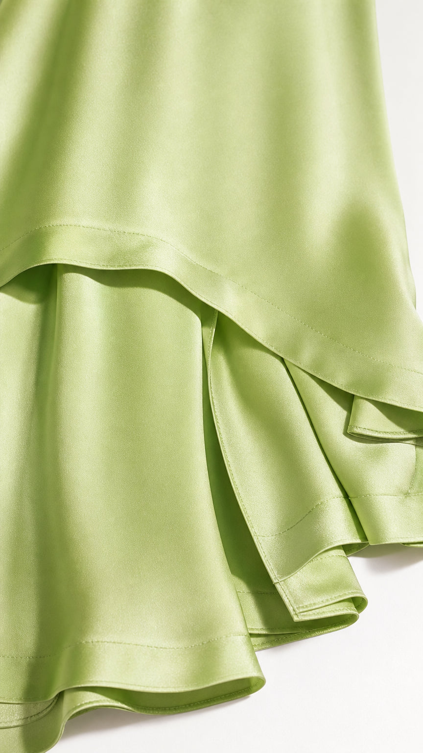 Close-up of smooth fabric layers on sage green dress