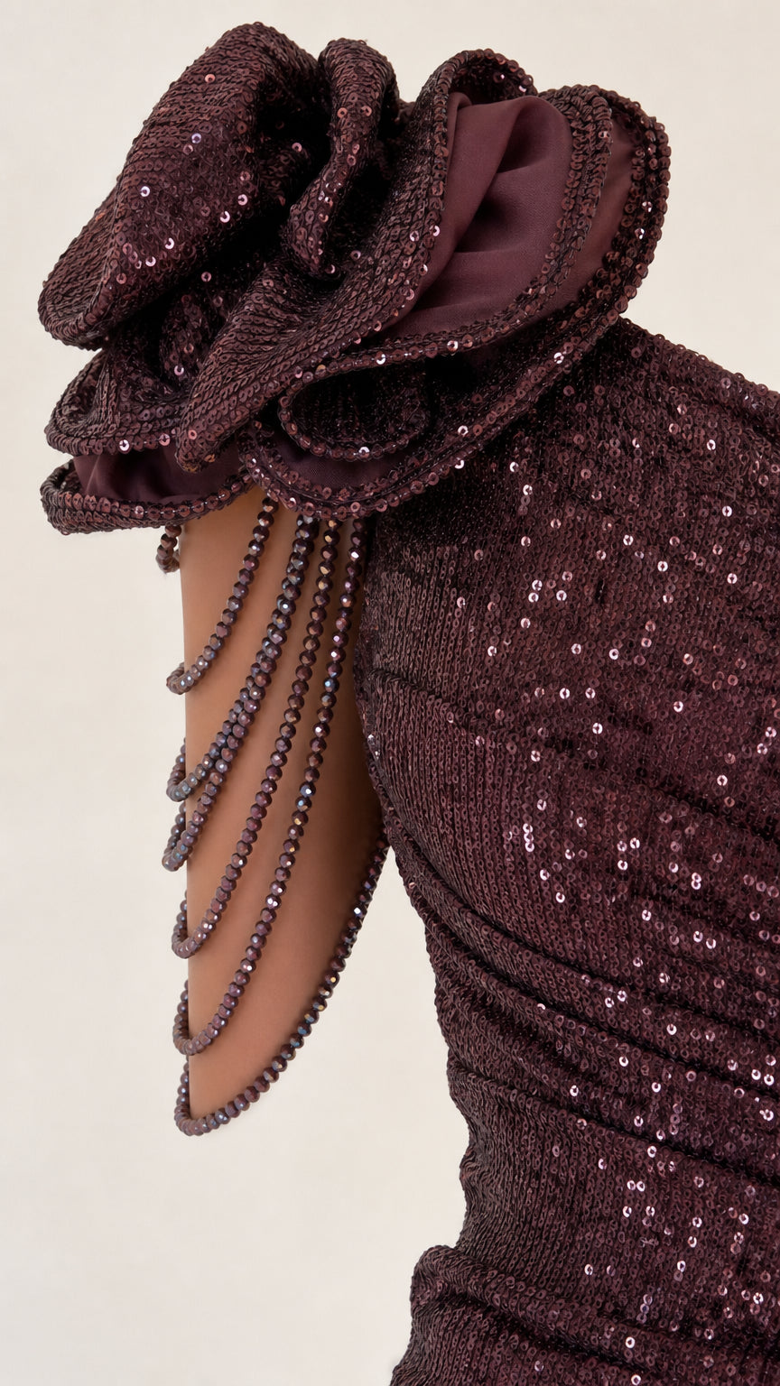 Close-up detail of 3D floral shoulder accent and beaded drapes