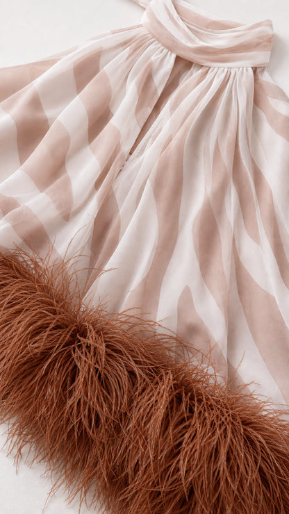 Close-up detail of plush feather trim and zebra patterned fabric