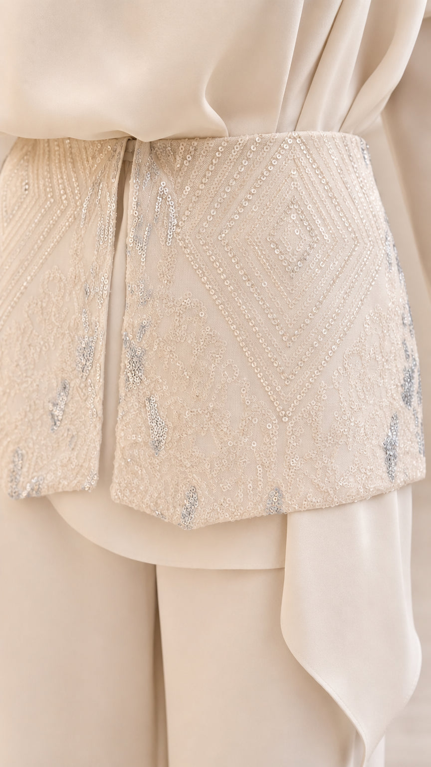 Close up of embellished waist detail on cream set