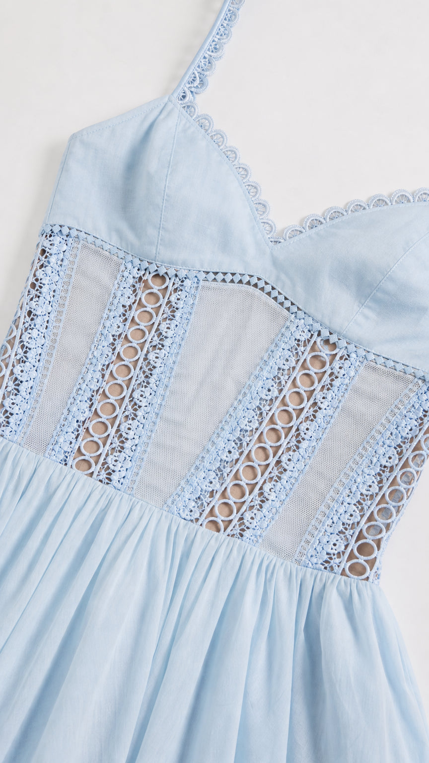 Close-up of bodice lace panels and trim on light blue dress