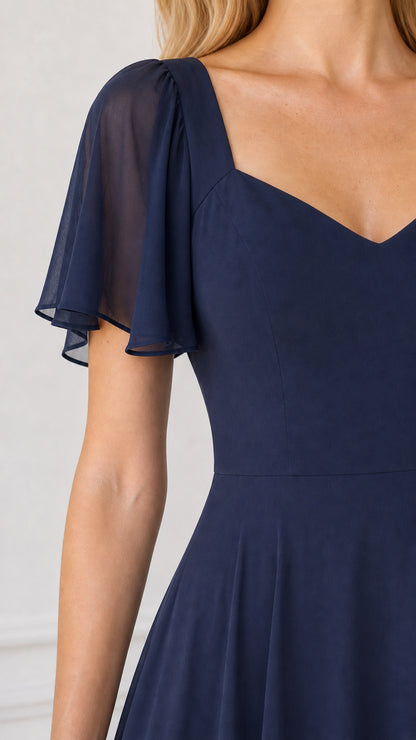 Close-up detail of sweetheart neckline and sheer flutter sleeve