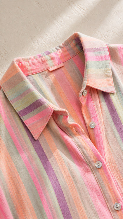 Close-up of pink striped shirt collar and button details