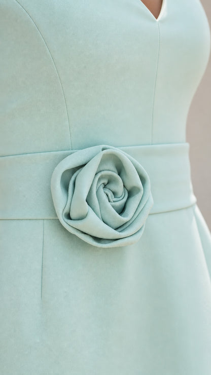 Close-up detail of the 3D rose applique on the dress waist