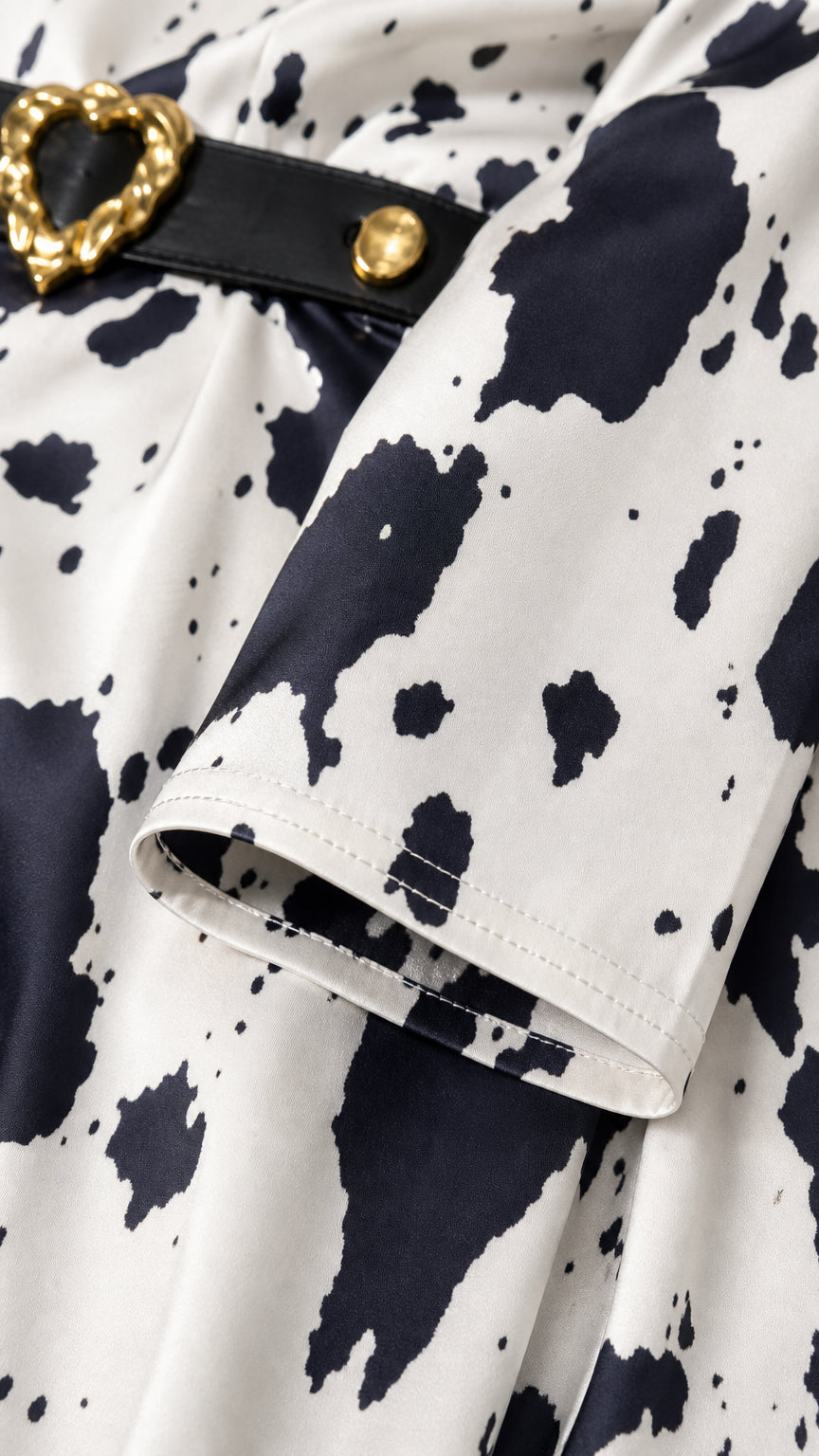 Close-up detail of the sleeve cuff and belt hardware
