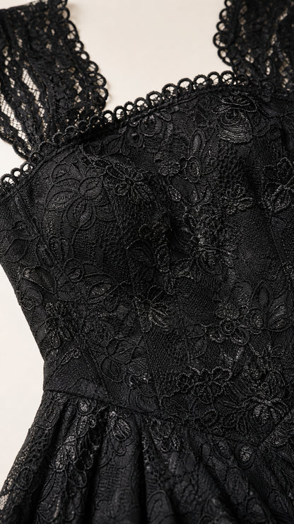 Close-up detail of lace bodice and straps on black dress