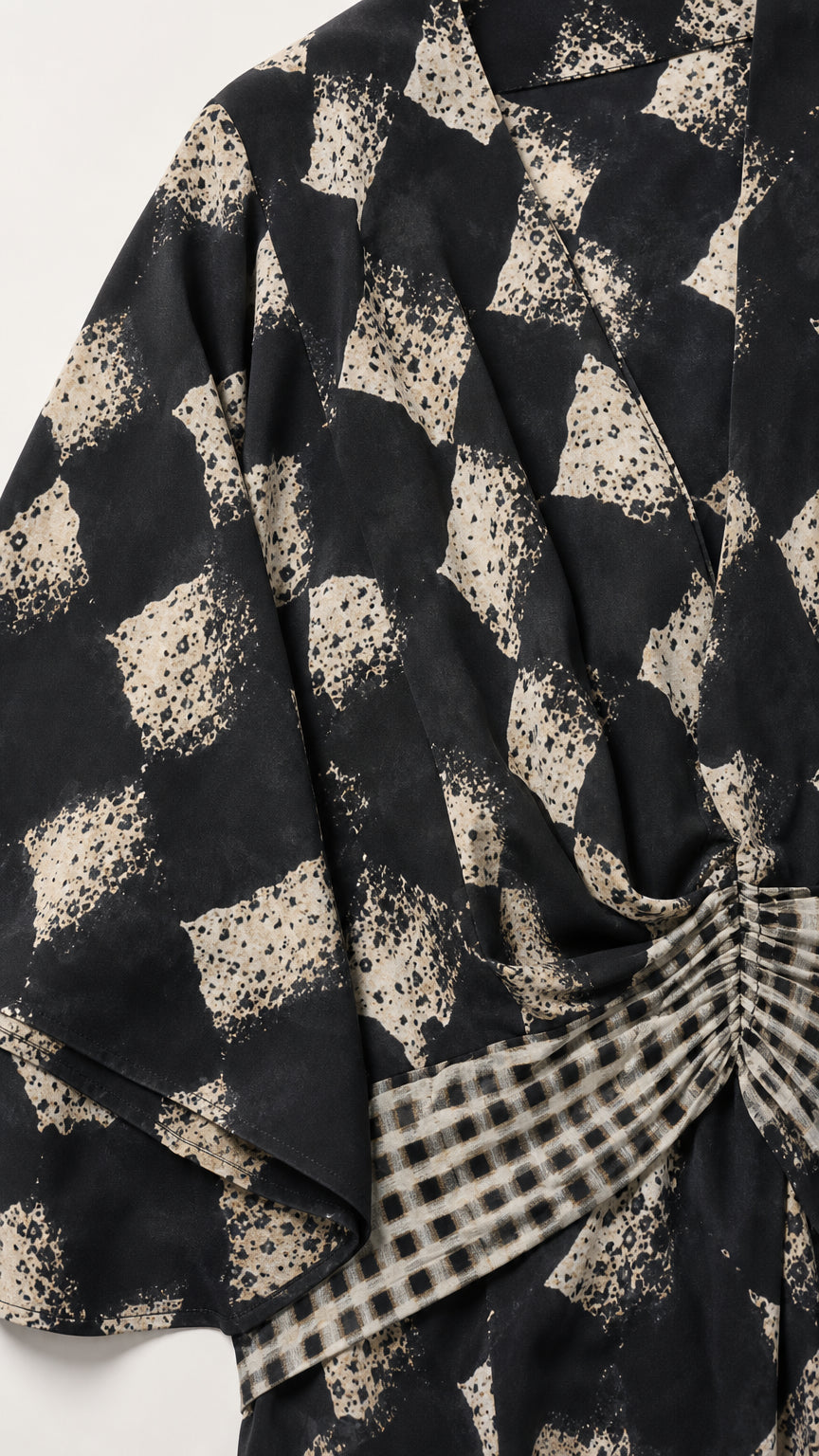 Close up of black geometric print fabric and waistband detail