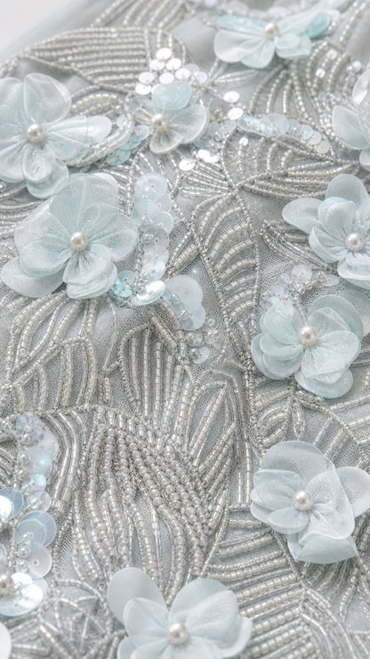 Close-up detail of Ice Blue 3D floral petals, pearls, and shimmering bead embroidery