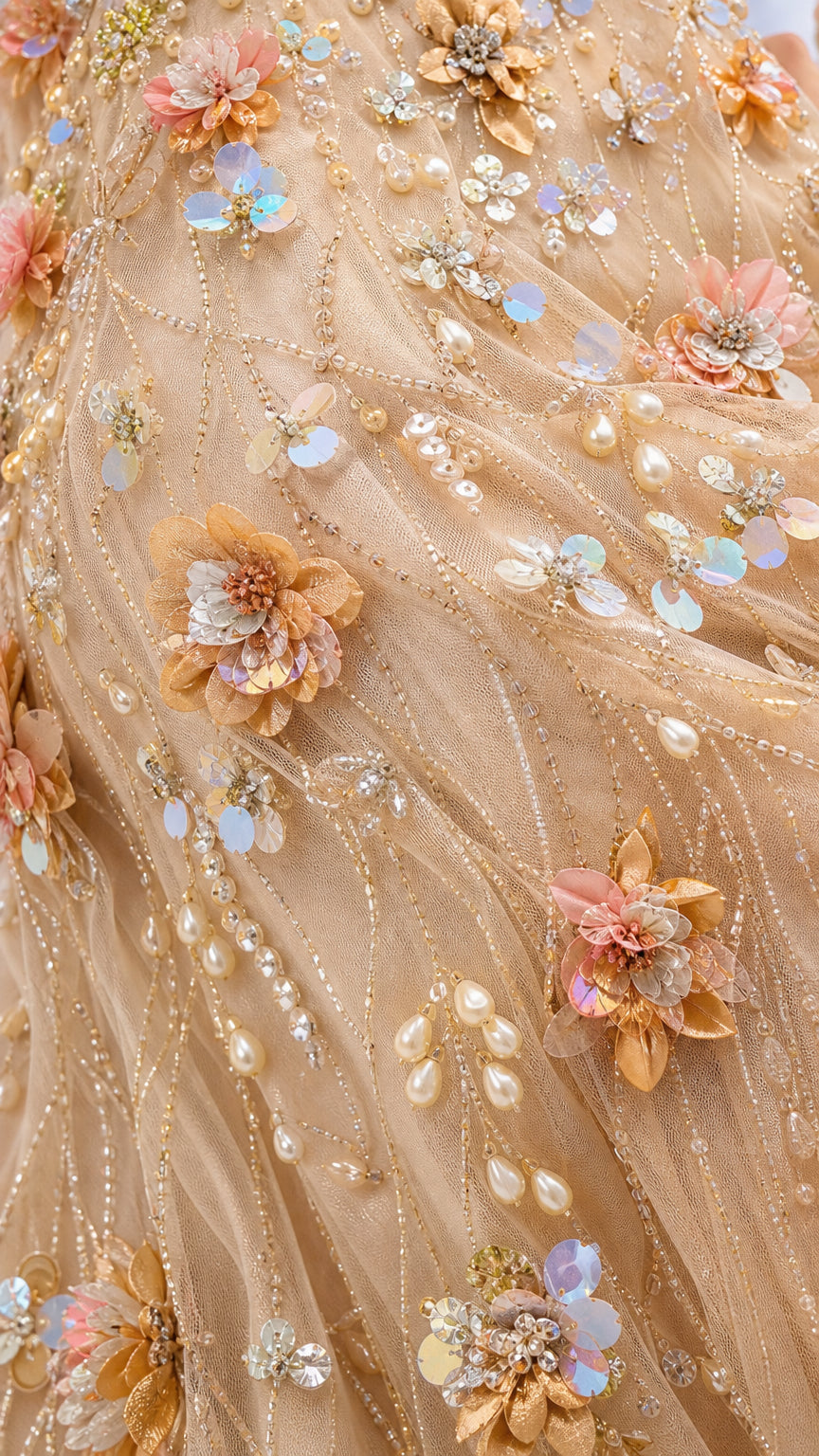 Close-up detail of hand-beaded floral appliqués and sequins