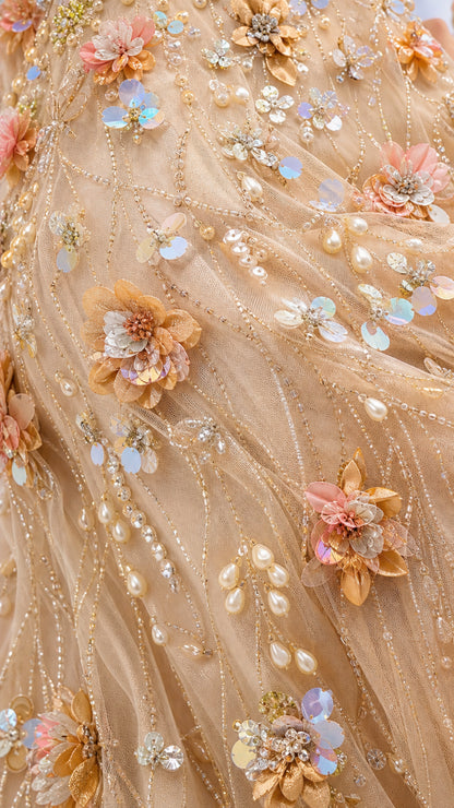 Close-up detail of hand-beaded floral appliqués and sequins