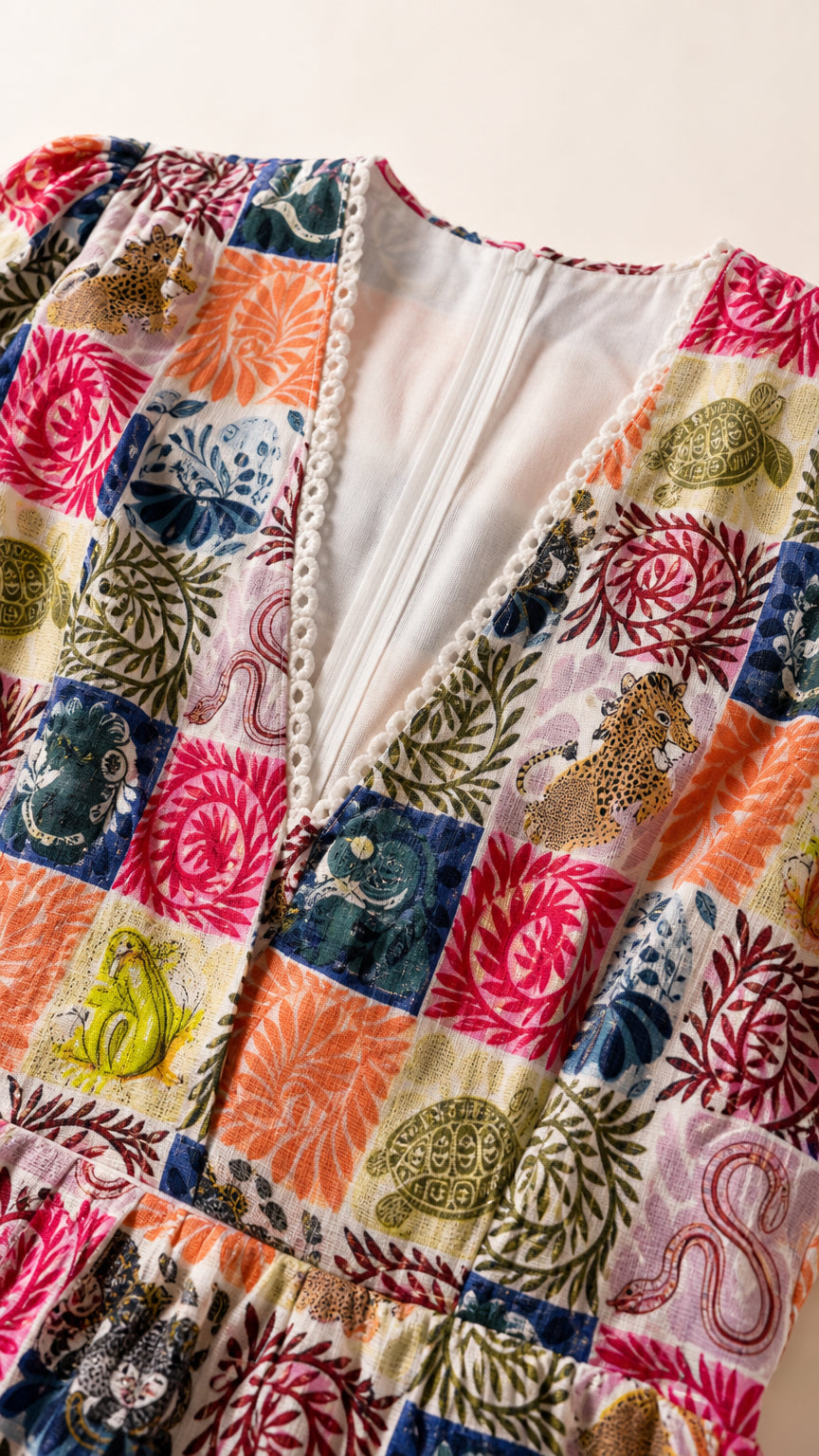 Close-up of V-neckline and patchwork print detail