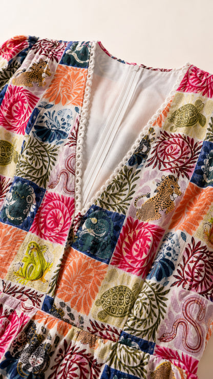 Close-up of V-neckline and patchwork print detail
