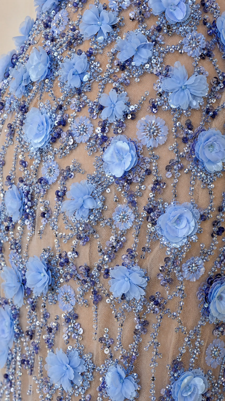 Close-up detail of blue fabric flowers and sequin embellishments