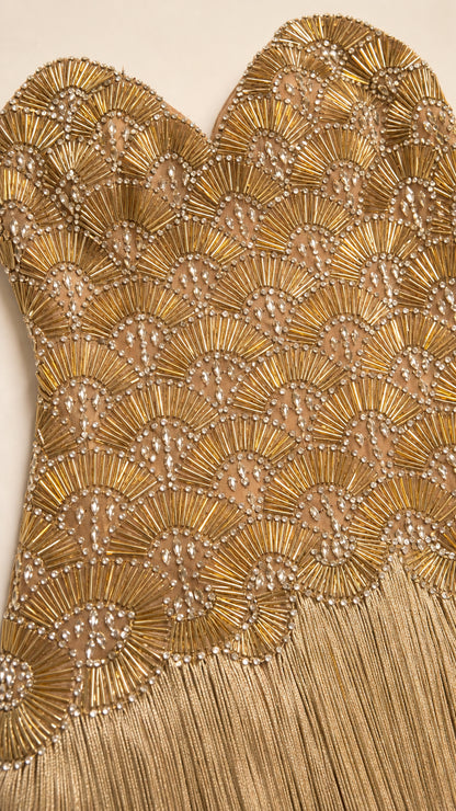 Close up of intricate metallic beadwork on the bodice