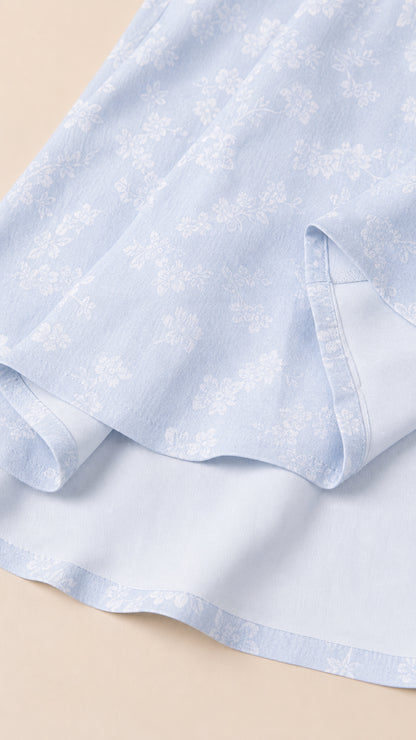 Close-up of Light Blue woven floral fabric and hemline